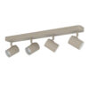 Ceiling-mounted track lighting bar with four beige adjustable spotlights facing downward.