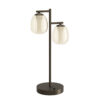 Dark bronze table lamp with two glass globe shades on a vertical stem and round base, modern dual-light design