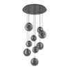 Modern chandelier with multiple smoky-gray glass spheres hanging at different heights from a round ceiling canopy.