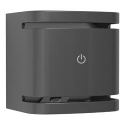 Close-up of a dark gray electronic device with a central power button icon on its front panel.