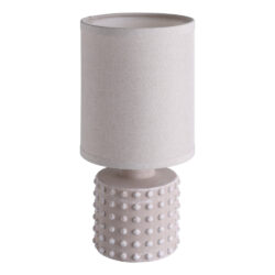 Table lamp with a beige fabric shade and a textured dotted base.