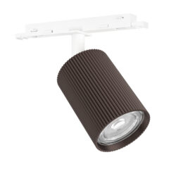 Brown ribbed cylindrical track light mounted on a white ceiling track, angled to shine downward into a space.